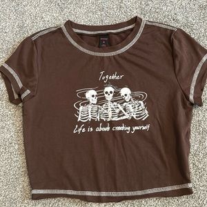 Brown,cropped t-shirt with white stitching on outside.